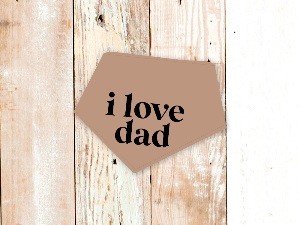 Adjustable "I Love Dad" dog bandana with snap closures on rustic wooden background
