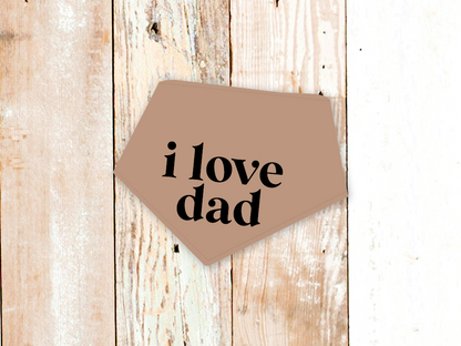 Adjustable "I Love Dad" dog bandana with snap closures on rustic wooden background