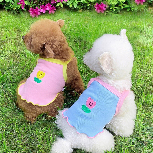 Lightweight Summer Dog Shirt in pink and blue mesh-like fabric, with contrasting trim and small flower appliqués.