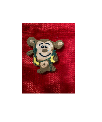 Organic dog cookie shaped like a dinosaur from Dinosaurs Organic Dog Cookie Box on red background