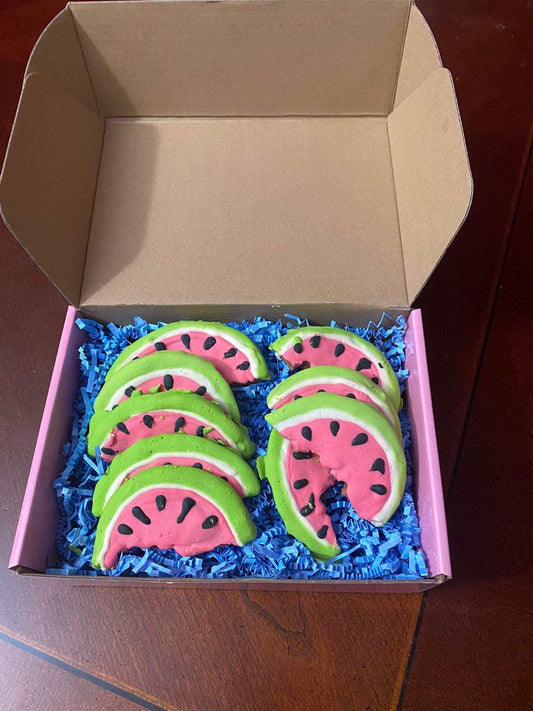 Organic Watermelon Dog Cookies shaped like watermelon slices with pink, white, and green icing and black seed details in a gift box