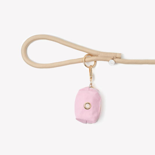 pink poop bag holder clipped to dog leash