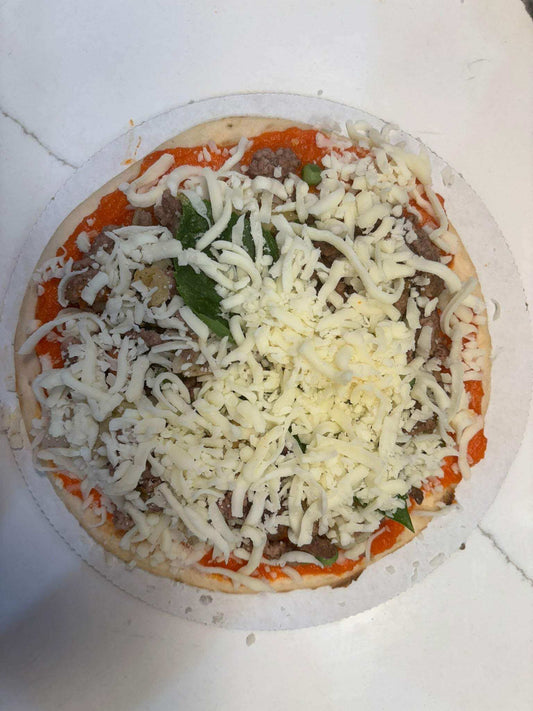 Pizza for Dogs with dog-safe carrot and pepper sauce, organic beef, peas, basil, and shredded mozzarella on a chewy crust