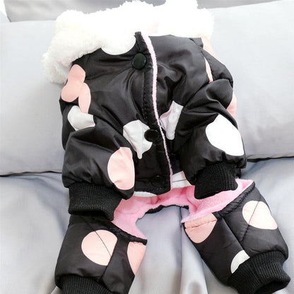 Waterproof dog snowsuit with legs and fleece lining featuring a black and pink polka dot design and snap closure