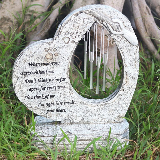 Heart-shaped pet memorial stone with paw print wind chimes for outdoor garden remembrance