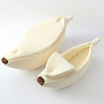 Creamy white banana-shaped plush pet bed with peelable cover for cats and small dogs