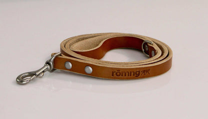 Handmade leather dog leash in camel color with nickel-plated brass swivel clip and rivets, branded with romng logo.