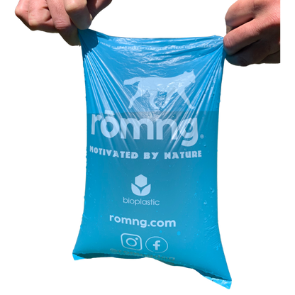 Blue bio-based dog poop bag stretched showing romng logo and bioplastic branding.
