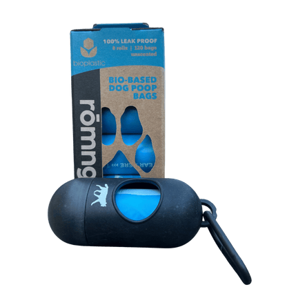 Bio-based dog poop bags in eco-friendly packaging with a black dispenser and keychain attachment