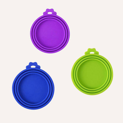 Set of three colorful BPA-free silicone Pet Food Saver Lids in purple, blue, and green, designed to keep pet food fresh.