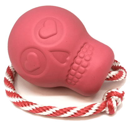 USA-K9 Skull Durable Rubber Chew Toy in pink with attached red and white rope, designed for heavy chewing and treat dispensing.