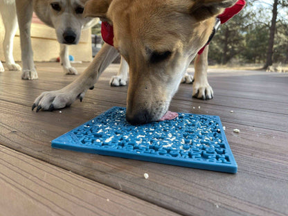 Dog licking blue Jigsaw Puzzle eMat lick mat with puzzle pieces for enrichment and anxiety relief outdoors