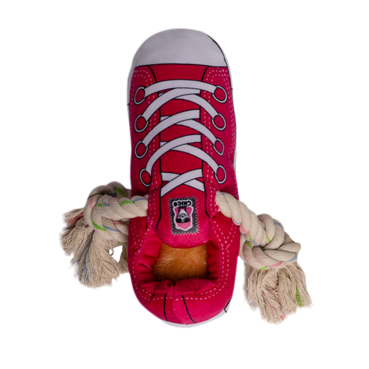 Pink squeaky plush sneaker dog toy with rope and treat compartment