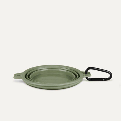 Green collapsible pet bowl with black clip for travel and easy storage